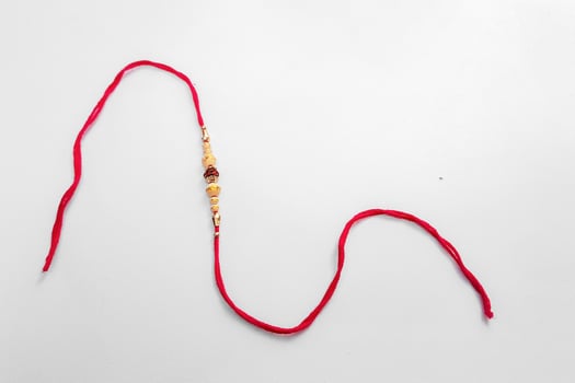 Elegant Detailed Rakhi Bracelet with Beads and Red Thread for Celebration,. photo