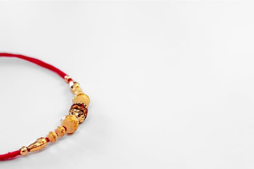 Elegant Detailed Rakhi Bracelet with Beads and Red Thread for Celebration., photo