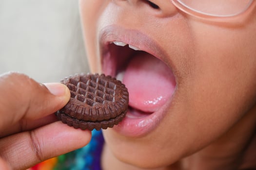 Child enjoys a chocolate sandwich cookie treat photo