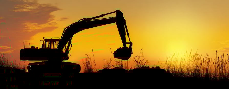 The silhouette of an excavator against a vibrant sunset sky. photo