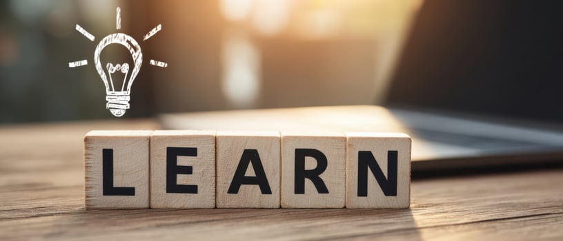 The wooden blocks spelling out 'LEARN' with a lightbulb icon symbolizing ideas. photo