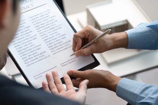 Signing Real Estate Contract. Client signing agreement with agent in modern office. photo