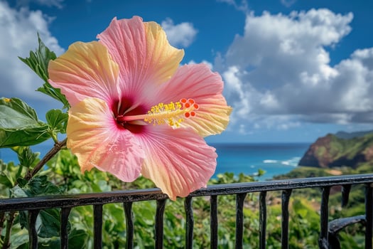 Vibrant hibiscus flower against a backdrop of sky and ocean photo