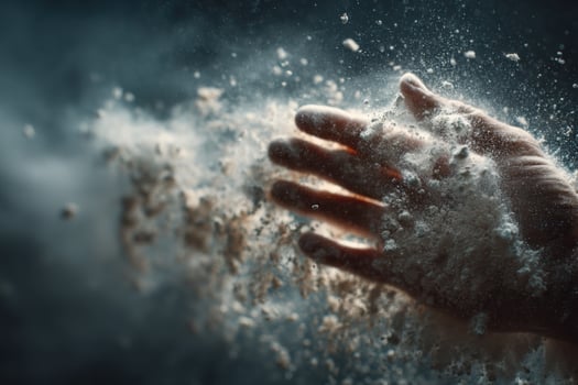 A hand is reaching out to the air with powder coming out photo