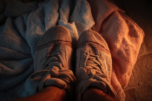 A person wearing sneakers on a towel photo