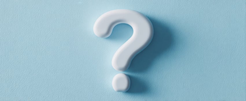 The Question Mark on a Soft Blue Background Representing Curiosity and Inquiry photo