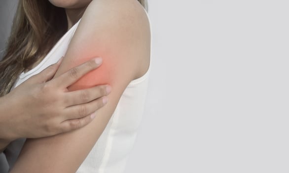 Young Woman Experiencing Arm Pain with Red Highlighted Area photo