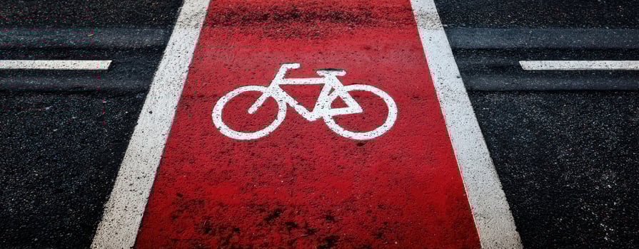 The bicycle lane marked with a bold red design for urban cycling safety. photo