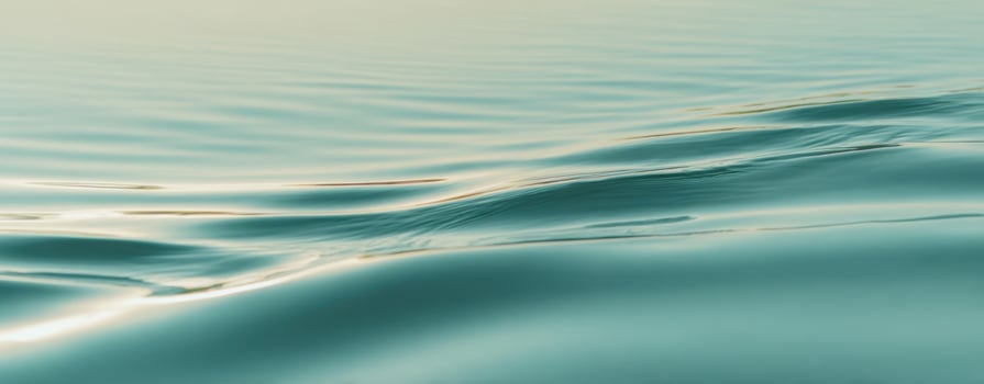 The tranquil beauty of gentle waves across a serene water surface. photo