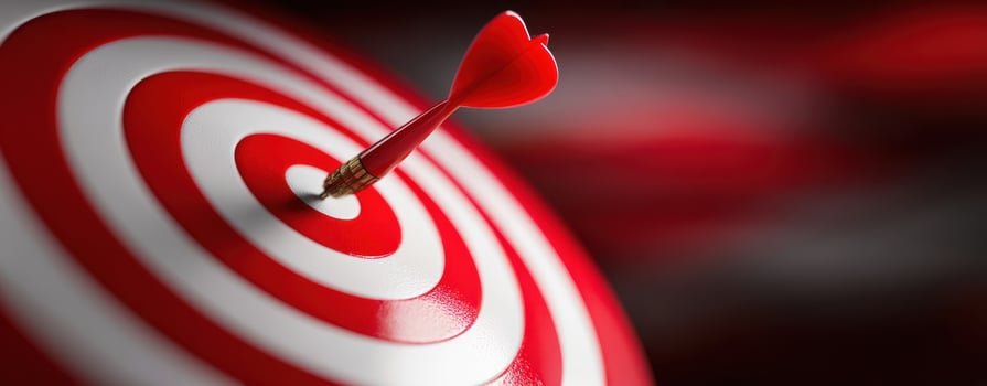 The dart hitting the center of a red and white bullseye target. photo