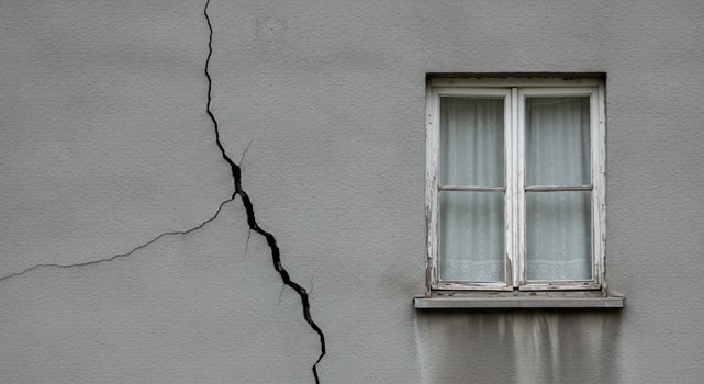 Cracked Gray Wall with Weathered White Window and Sheer Curtain photo