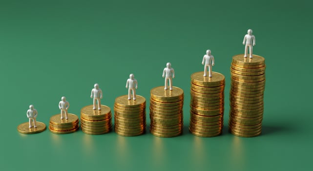 Figurines on Ascending Stacks of Gold Coins on Green Background photo