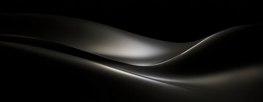 The Elegant Curves of Light on a Smooth Black Surface photo