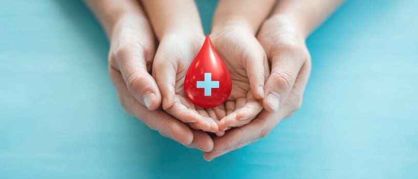 The Hands Holding a Symbolic Blood Drop for Health and Donation Awareness photo