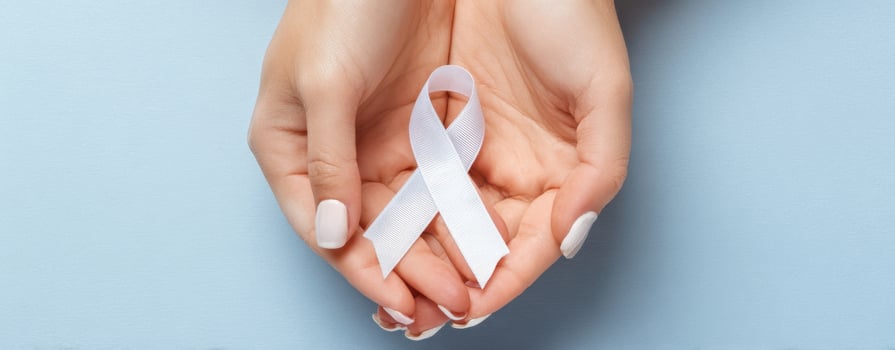 The Hands Holding a White Awareness Ribbon Signifying Support and Hope photo