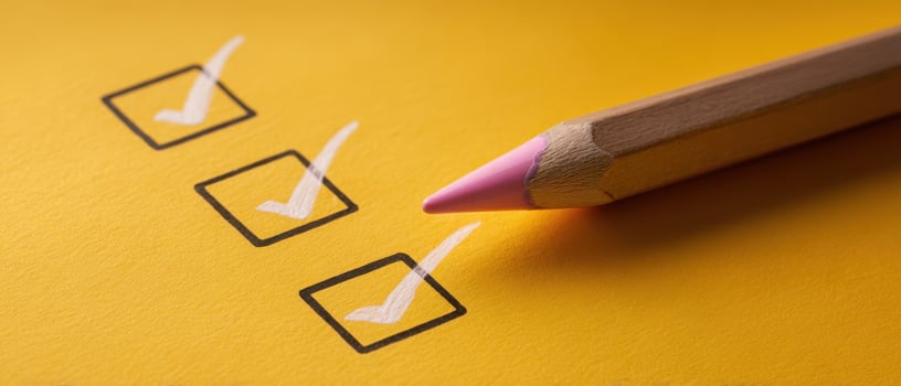 The colorful checklist with pink pencil on bright yellow background. photo