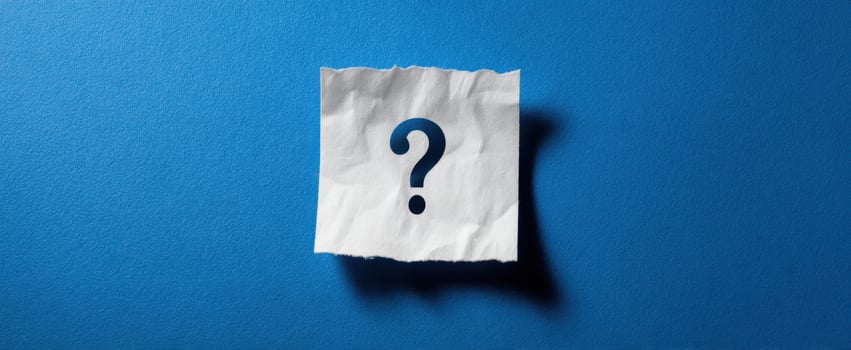 The crumpled paper note with a question mark on blue background photo