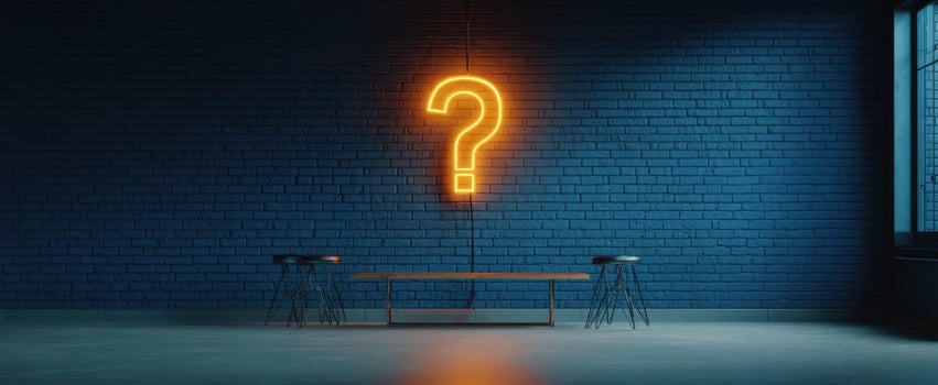 The glowing question mark illuminating a minimalist interior space. photo