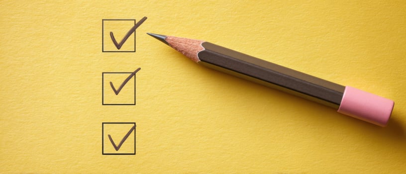 The pencil beside a checklist on a vibrant yellow background. photo