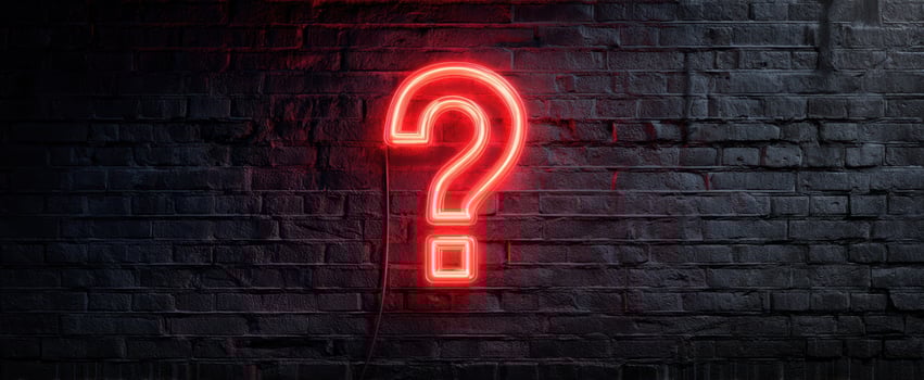 The glowing neon question mark sign on a dark brick wall. photo
