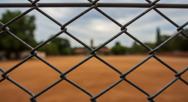 A view of a baseball field through a chain link fence photo