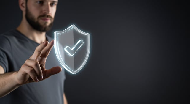 A man holding a glowing shield with a check mark on it photo