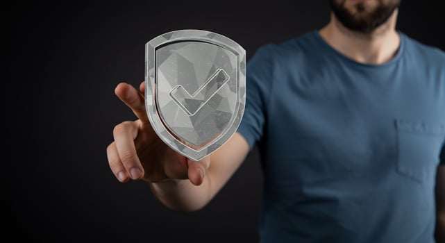 A man holding a shield with a check mark on it photo