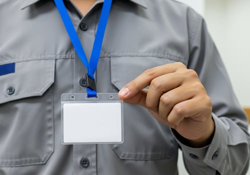 Employee holding badge to access building, office background, for presentation photo