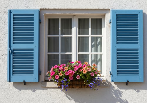 A window with blue shutters and a flower basket photo
