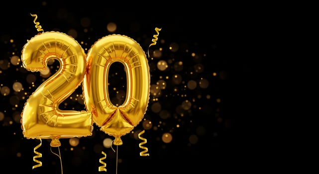 Golden 20 balloons floating for birthday celebration on black with lights background photo