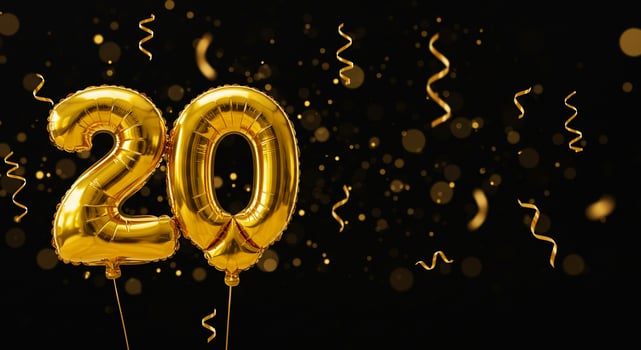Golden '20' Balloons Celebrate Anniversary on Black Background with Bokeh Lights photo