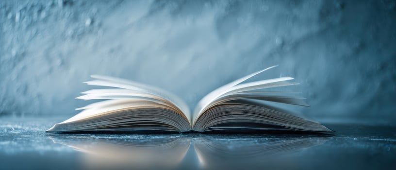 The open book rests on a reflective surface inviting quiet contemplation. photo