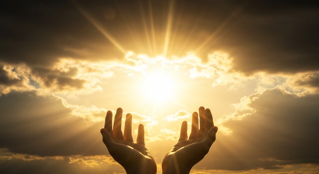 Hands Reaching for Divine Light in Cloudy Sky photo