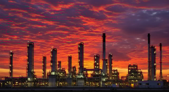 An oil refinery at sunset with red clouds photo
