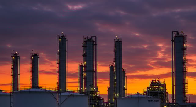 Industrial Refinery Silhouettes Against a Vibrant Sunset Sky photo