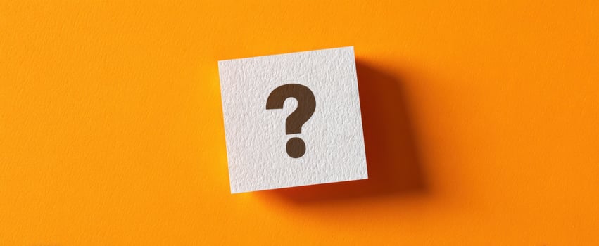 The Question Mark on a Vibrant Orange Background Representing Curiosity photo
