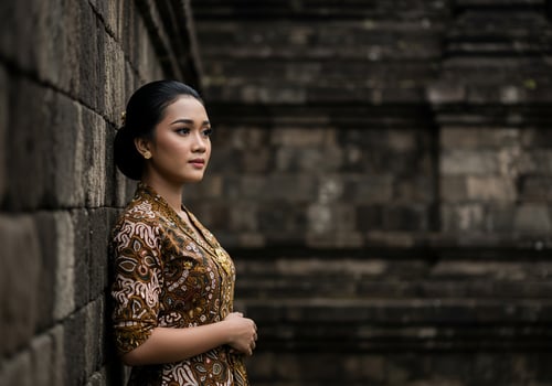 Javanese woman posing at Borobudur temple wall, Java, Indonesia. Tourism concept photo
