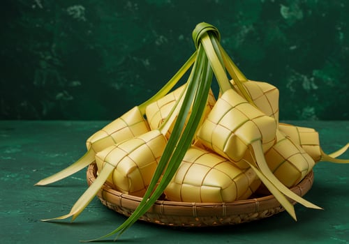 Ketupat in a basket during Eid festive background for cooking recipes, greeting cards photo
