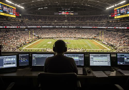 Man operating control panel at stadium for broadcasting events to audience photo
