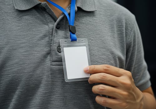 Man with blank ID badge at business event for professional use, closeup view photo