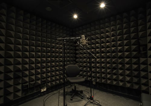 Microphone and chair inside soundproof booth for audio recording in studio photo