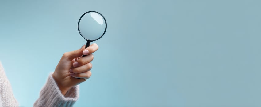 The magnifying glass held by a hand emphasizes the art of close observation. photo