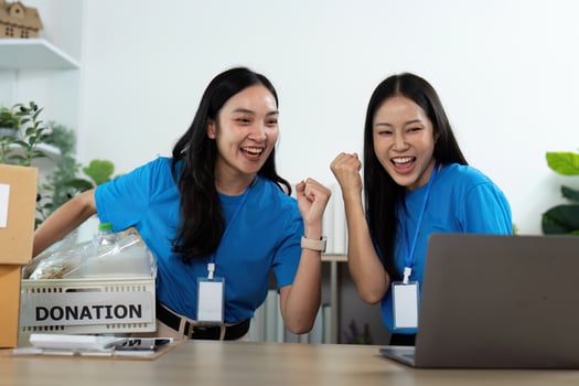 Excited volunteers celebrating success at donation center photo