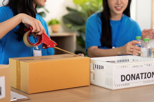 Volunteer organizing donations with care and teamwork photo