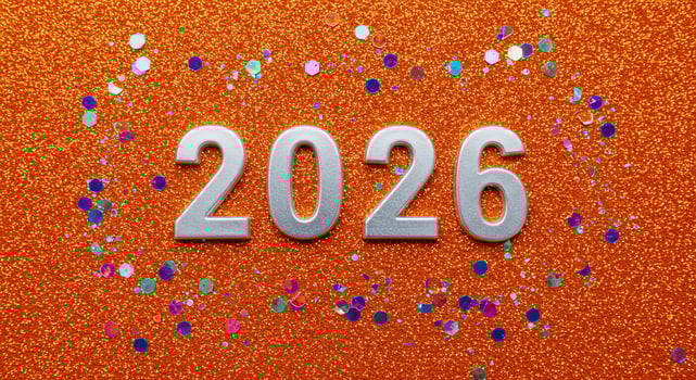 Number 2026 with bokeh confetti on a vibrant orange glitter background photo