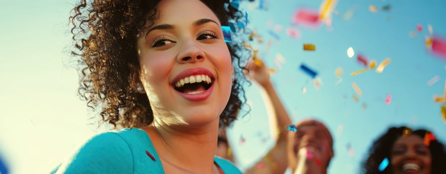 The joyful celebration of a young woman surrounded by friends and confetti. photo