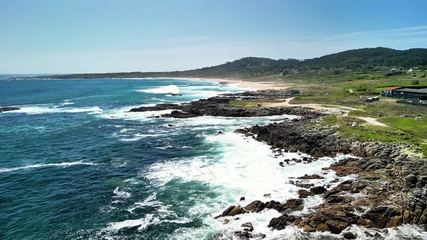 A breathtakingly beautiful coastal landscape showcasing dynamic waves and rugged rocky shores photo