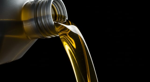 A close up of a bottle of oil pouring out photo