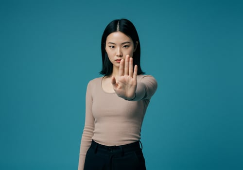 Asian woman making stop sign with hand photo