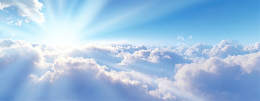 The Serene Sky Illuminated by Bright Sunlight Over Fluffy Clouds photo